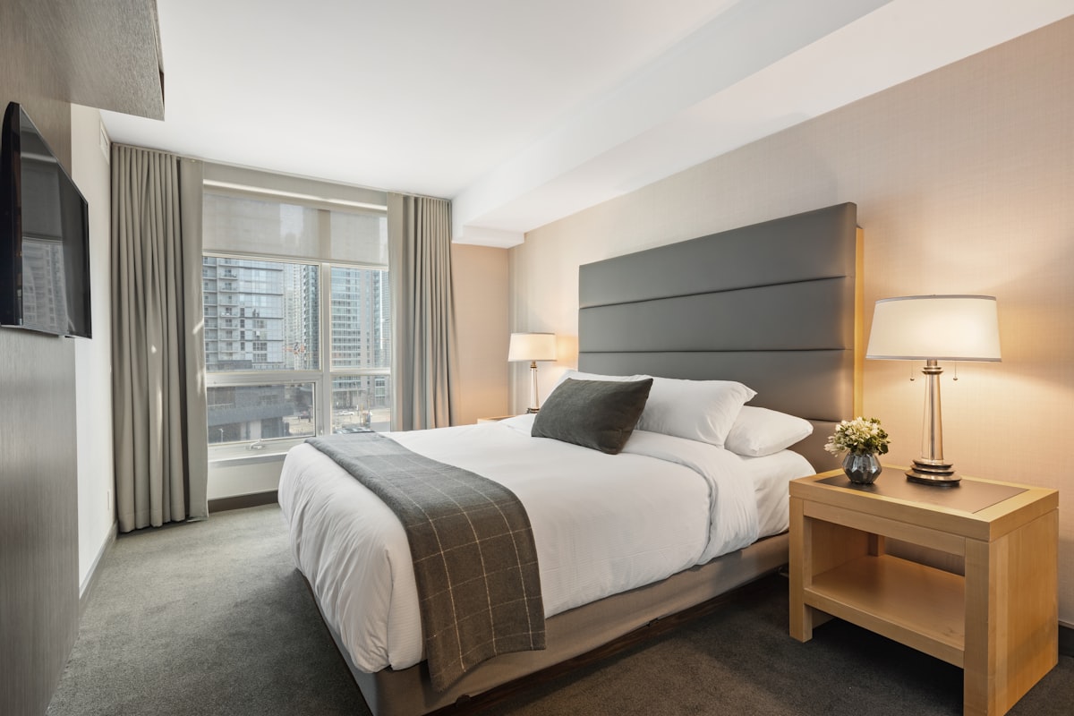 A clean bedroom with soft natural light — the intentional rest of Bed Rotting